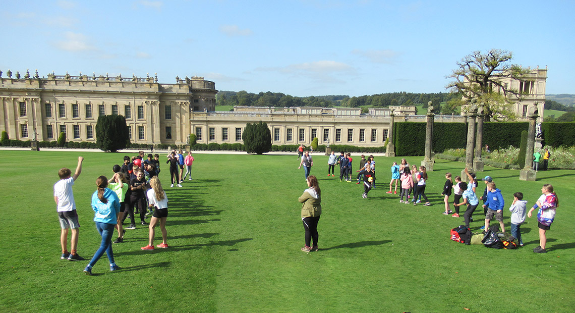 First Year pupils play in front of Chatsworth House during their residential