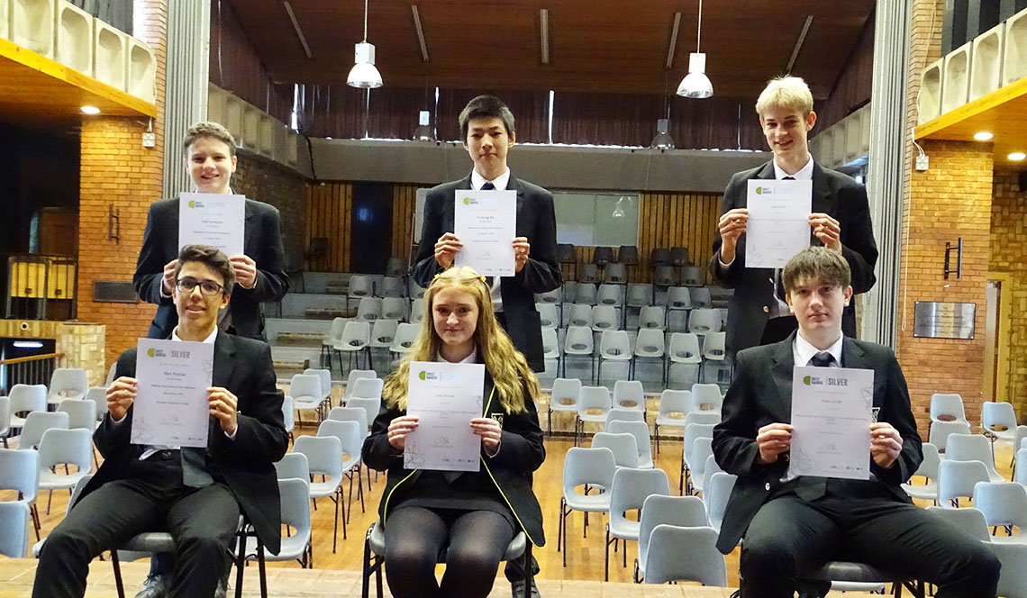 Students collect their Silver Chemistry Crest Award certificates