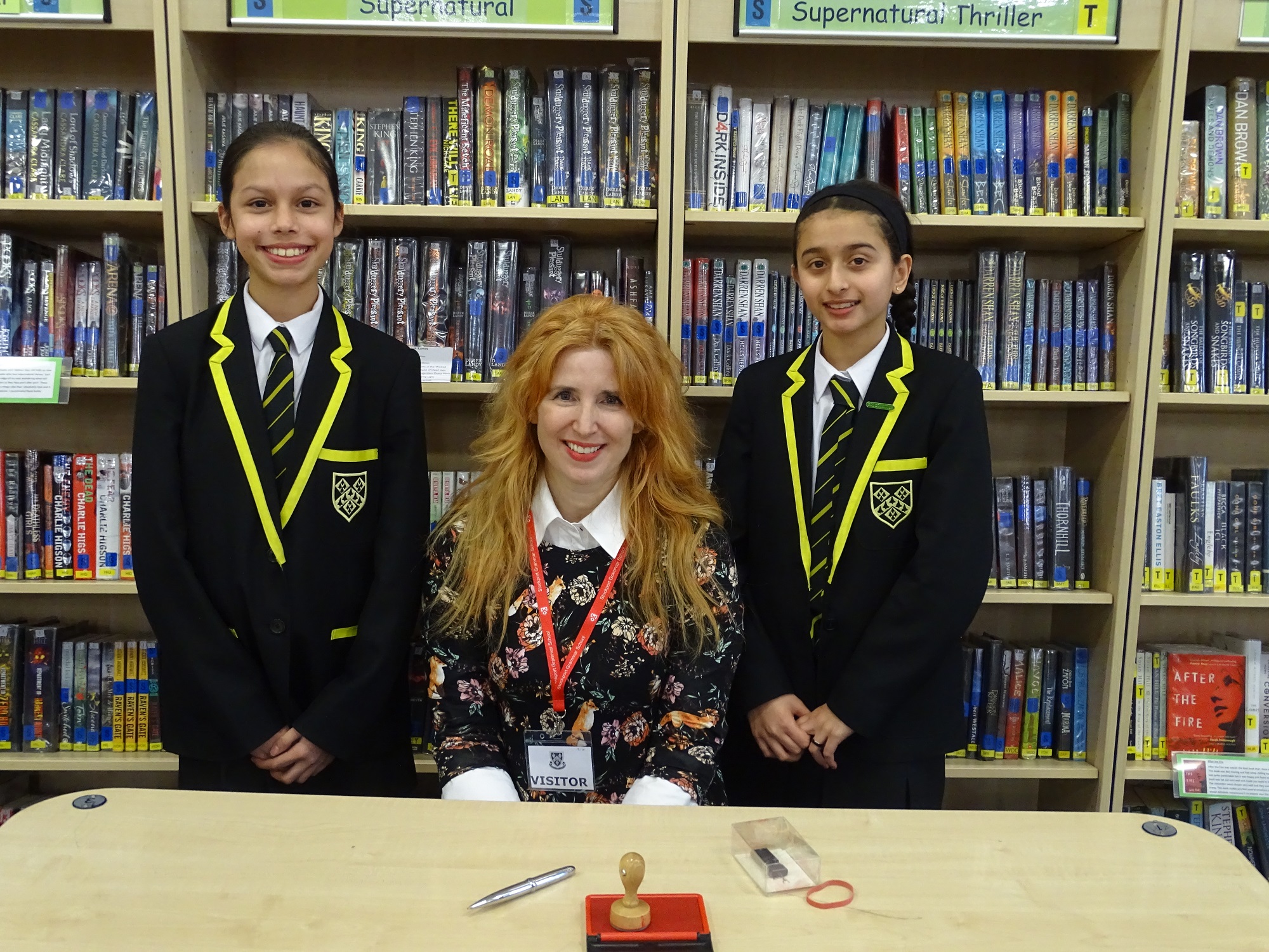 Author M A Bennett poses for a photo with pupils