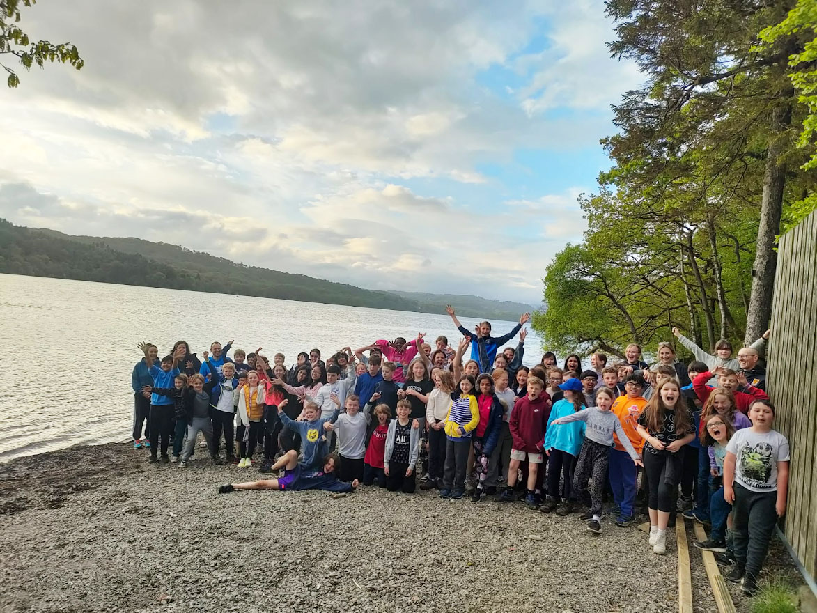 Year Six pupils pose for a picture on the beach during their residential