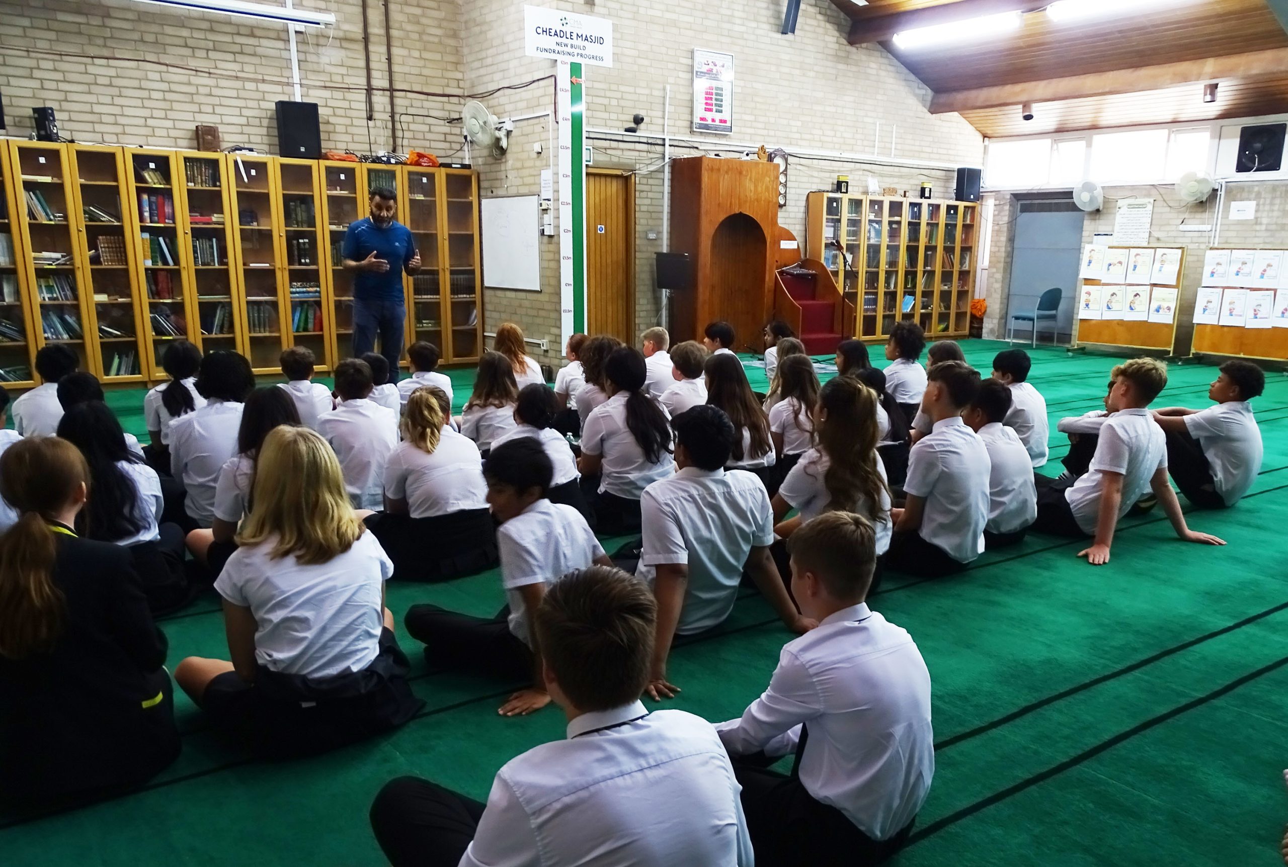 Second Year Religious Studies pupils listen to a talk during a trip to a Mosque