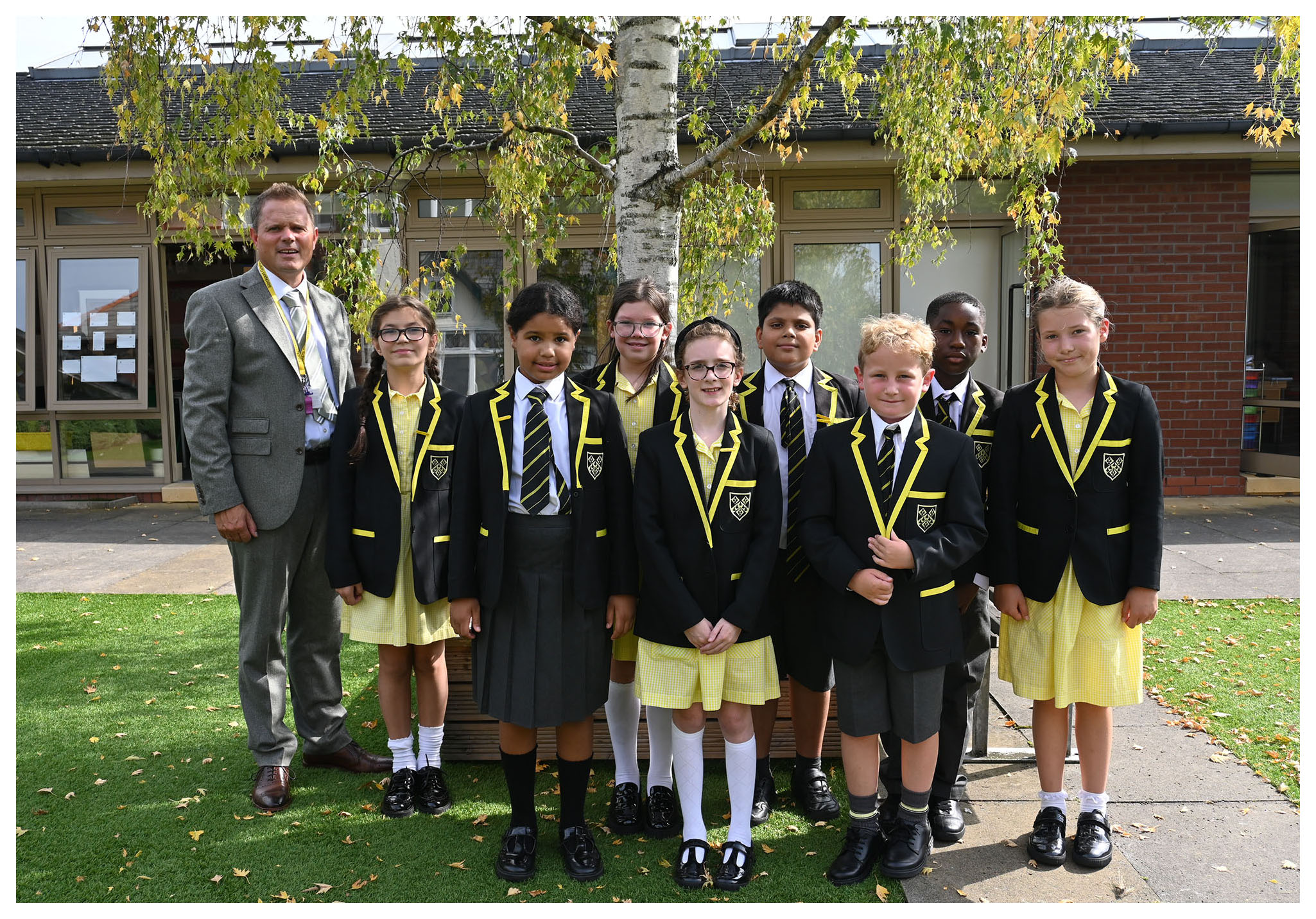 The Junior School House Captains pose for a photo with the Head