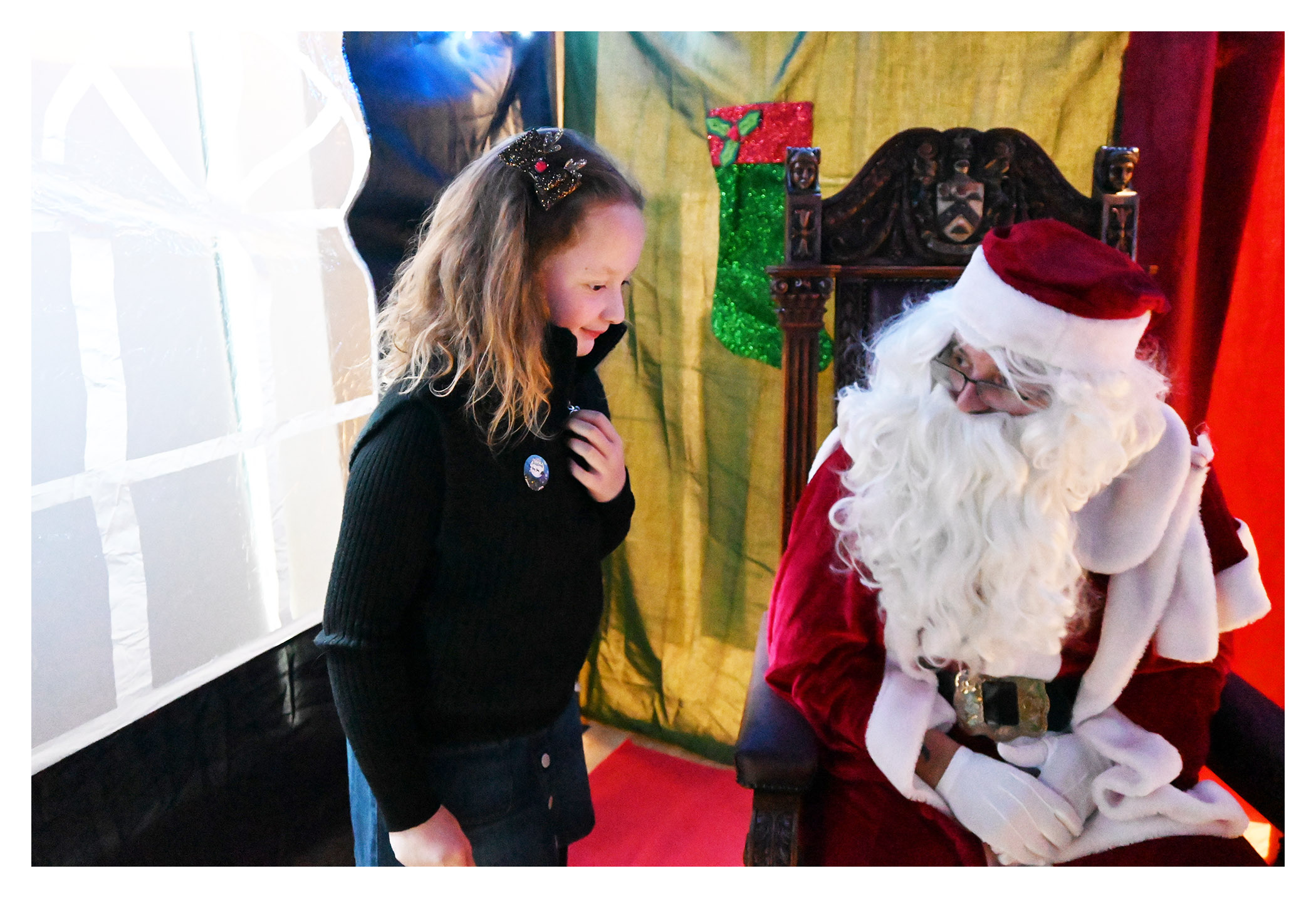 A child meeting Santa at the 2023 SPA Christmas Fair