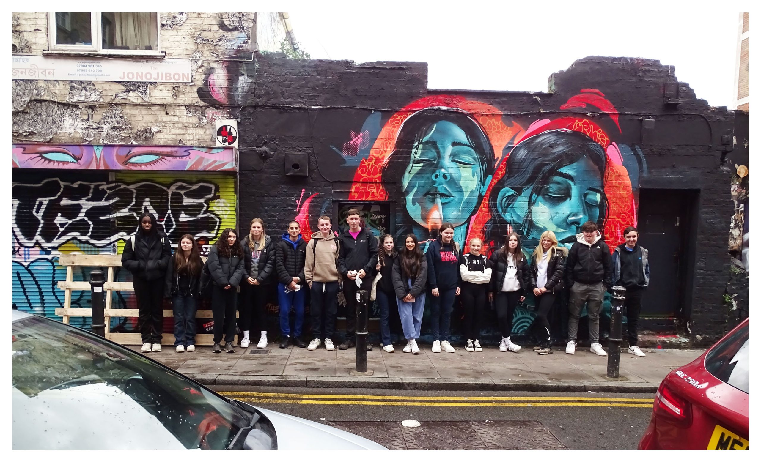 Food and Nutrition students pose for a photo in front of street art in London