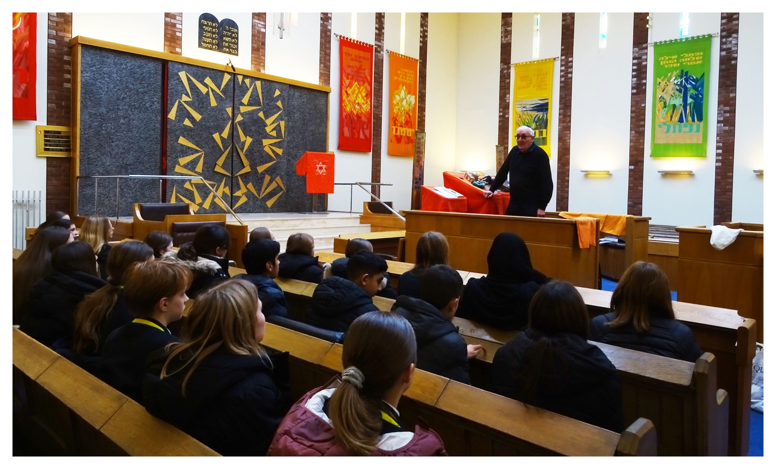 Second Year pupils listen to a talk during a visit to Gatley Synagogue