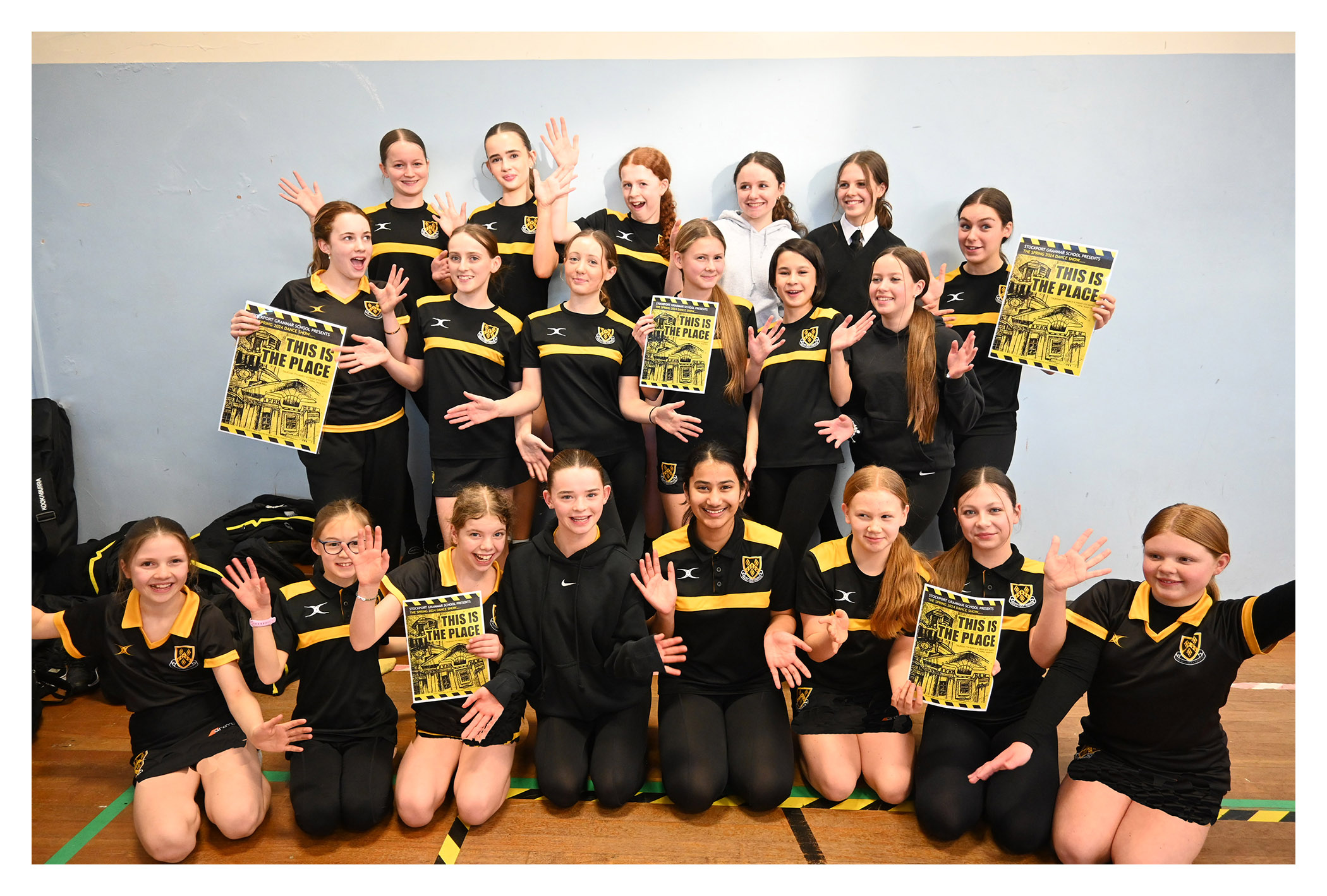 Pupils pose with posters for the 2024 Dance Show