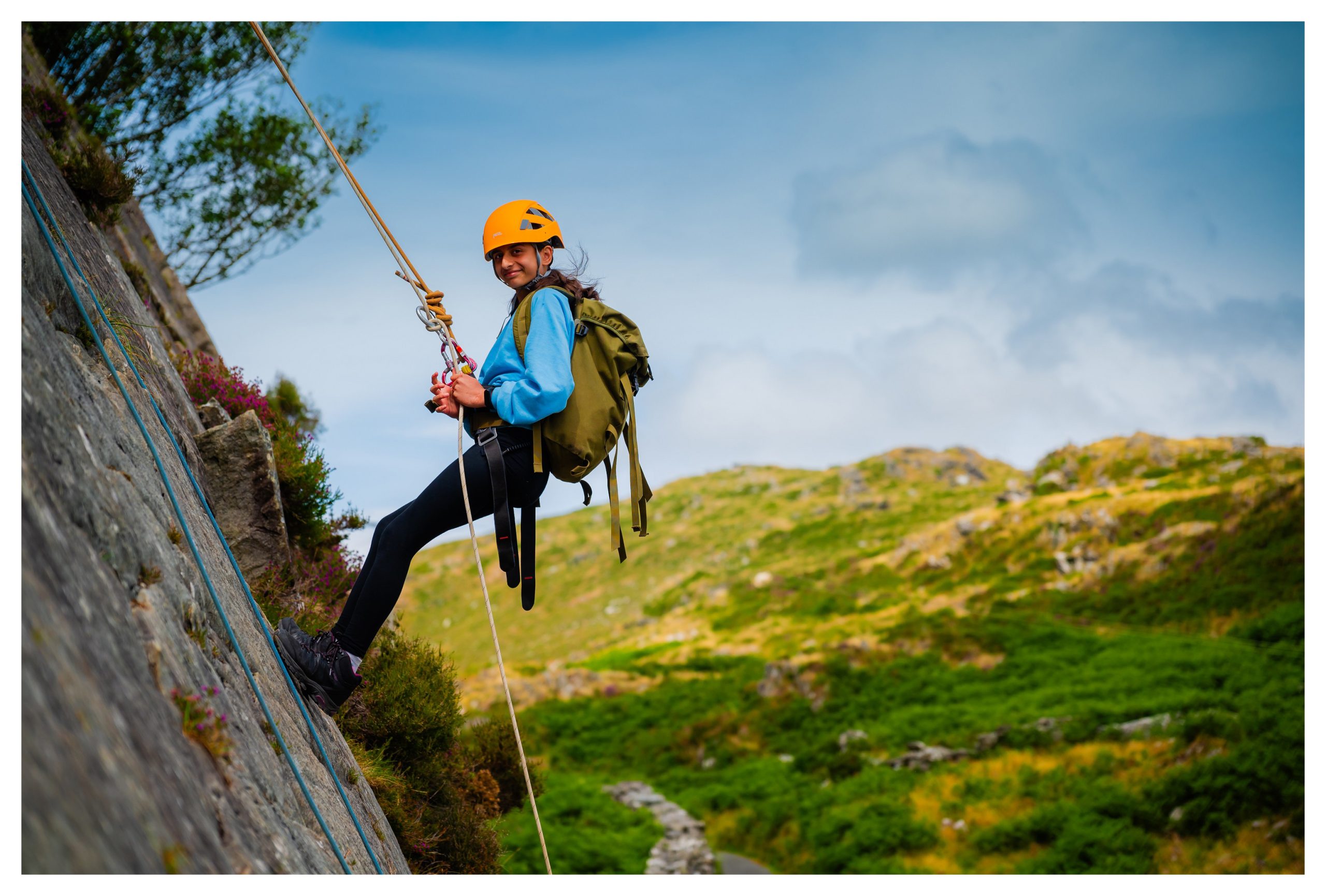 A girl abseiling on an outdoor trip